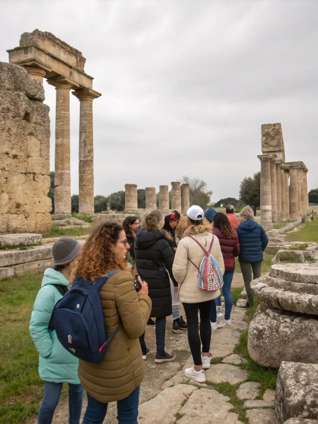 A vibrant image of a guided tour through a historical site in Aurillac, with participants listening attentively to the guide.
